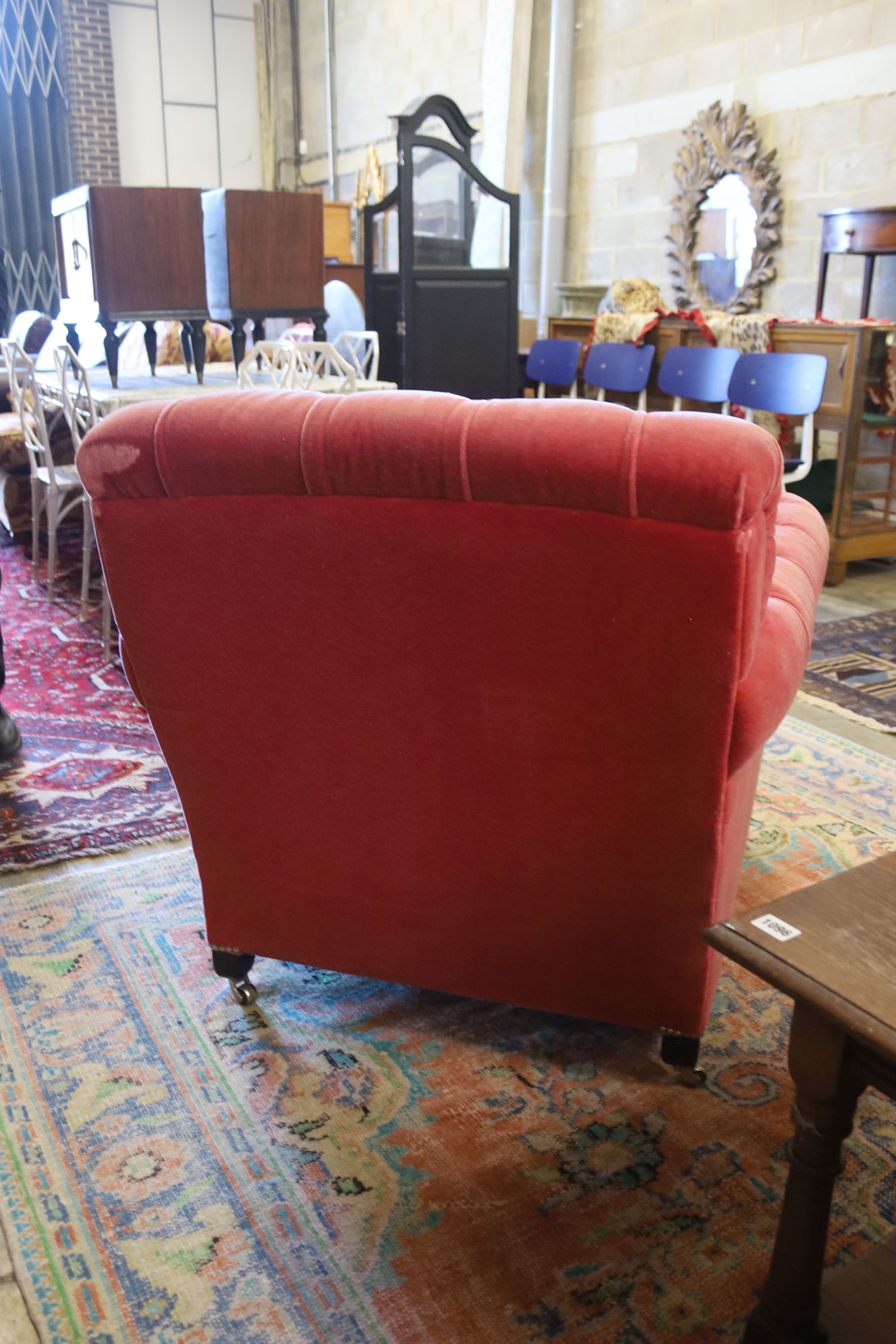 A George Smith armchair upholstered in buttoned pink fabric on turned legs, width 86cm, depth 95cm, height 80cm